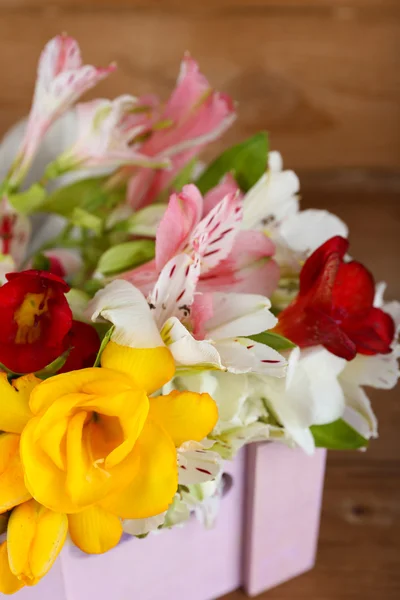 Beautiful spring flowers on wooden background — Stock Photo, Image