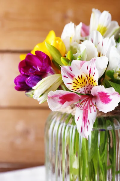 Beautiful spring flowers on wooden background — Stock Photo, Image