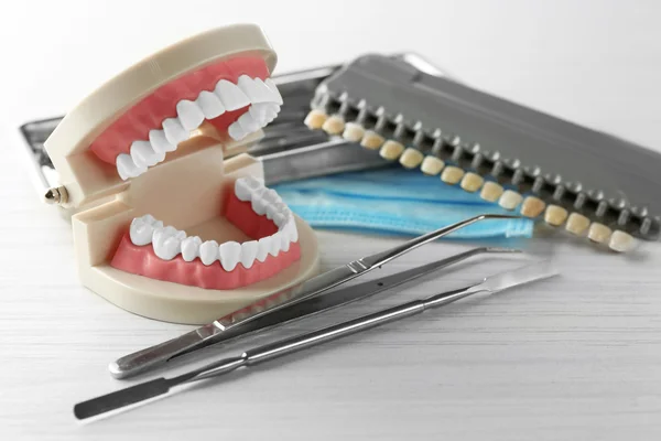 White teeth and dental instruments on table background — Stock Photo, Image