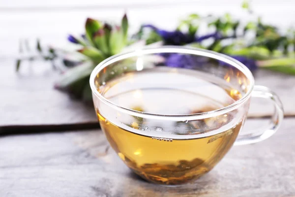 Cup of herbal tea with flowers — Stock Photo, Image