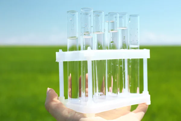 Female hand with test tubes — Stock Photo, Image