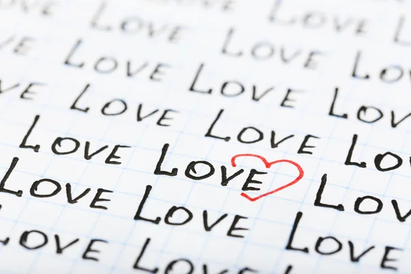 Words LOVE written on sheet of paper background — Stock Photo, Image