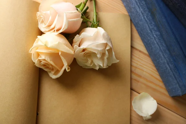 Fresh roses on old notebook — Stock Photo, Image