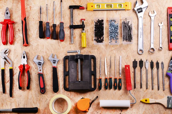 Set of tools on plywood, top view — Stock Photo, Image