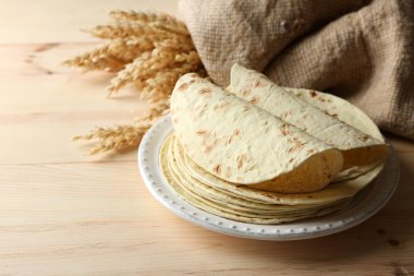 ev yapımı kepekli un tortilla ahşap masa arka plan üzerinde plaka üzerinde yığını