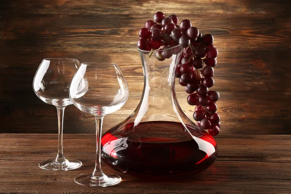 Glass carafe of wine on wooden background — Stock Photo, Image