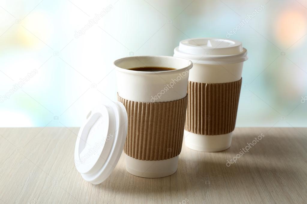 Paper cups of coffee on table