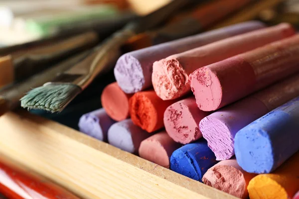 Paintbrushes with colorful chalk pastels in box close up — Stock Photo, Image