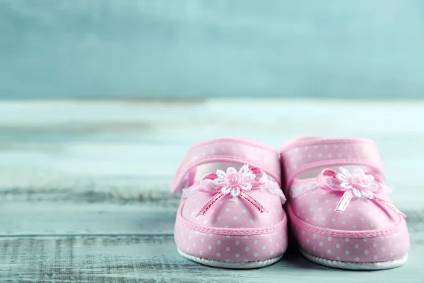 Sapatos de criança rosa no fundo de madeira — Fotografia de Stock