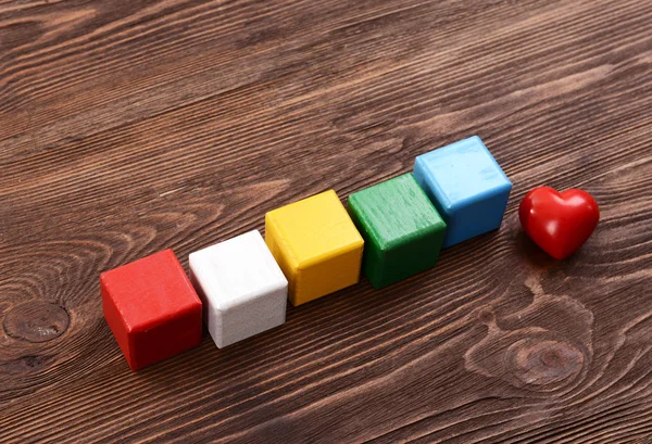 Colorful cubes for inscriptions on wooden background — Stock Photo, Image