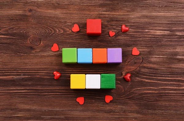 Colorful cubes for inscriptions on wooden background — Stock Photo, Image