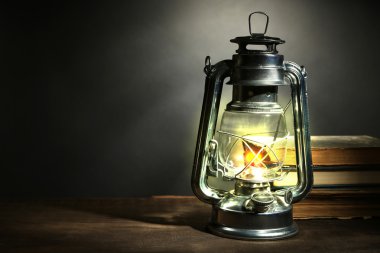 Kerosene lamp and letters on dark grey background clipart