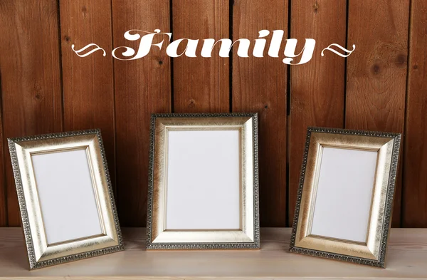 Photo frames on wooden surface, on wooden wall background — Stock Photo, Image