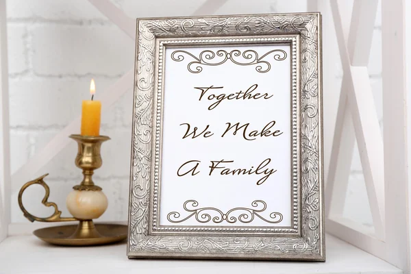 Photo frame on shelf with candlestick on brick wall background — Stock Photo, Image