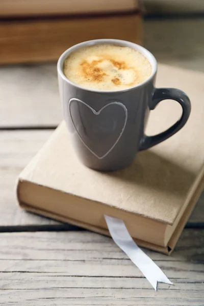 Still life with cup of coffee and book, close up