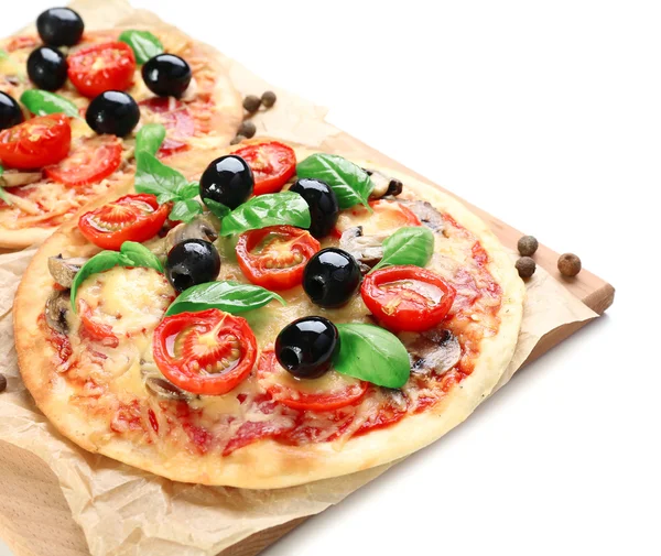 Gustosa pizza con verdure e basilico sul tagliere isolato su bianco — Foto Stock