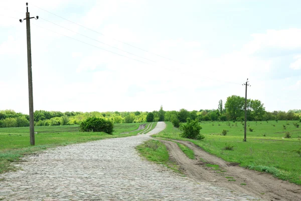 Country road over blue sky background — Stock Photo, Image