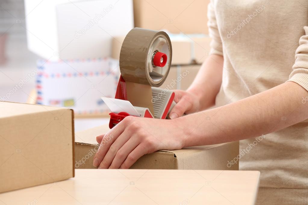 Woman packs parcel in post office