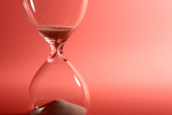 stock image Hourglass on pink background