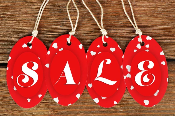 Sale tags on wooden background — Stock Photo, Image