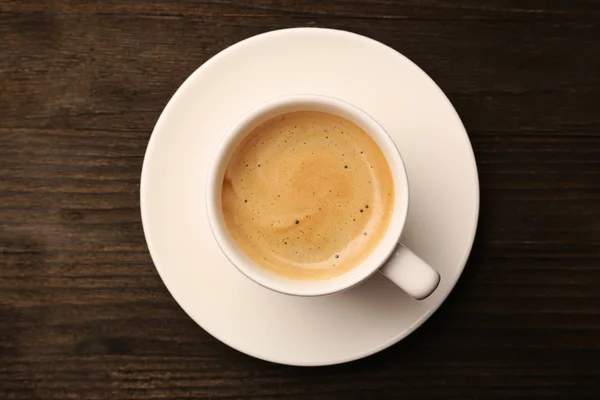 Xícara de café na mesa de madeira, vista superior — Fotografia de Stock