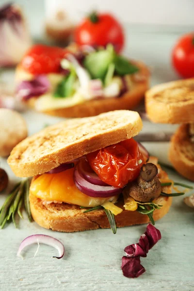 Tasty sandwiches on wooden table, close up — Stock Photo, Image