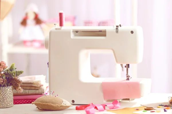 Sewing machine on table in workshop — Stock Photo, Image