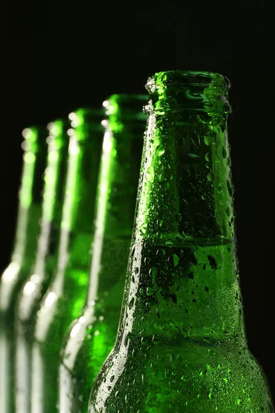 Glass bottles of beer on dark background — Stock Photo, Image