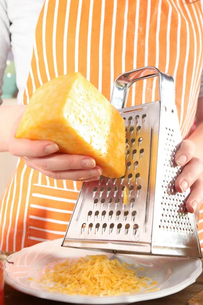 Closeup of female hands grating cheese — Stock Photo, Image