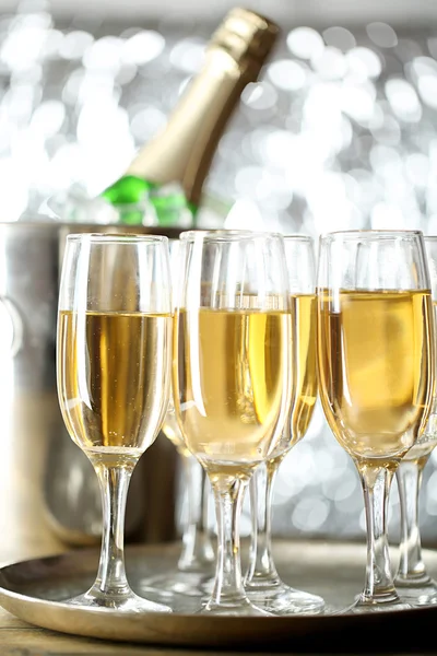 Glasses of champagne on bright background — Stock Photo, Image