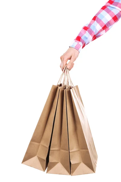 Mão feminina segurando saco de compras de papel isolado no branco — Fotografia de Stock