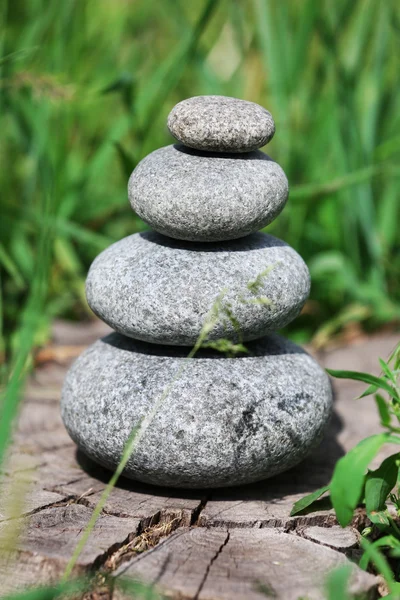 Stack of spa stones over green grass background — Stock Photo, Image