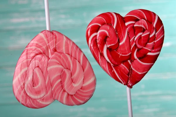 Bright lollipops in shape of heart on wooden background — Stock Photo, Image