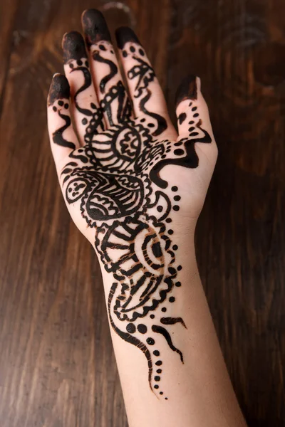 Hand painted with henna on wooden background — Stock Photo, Image