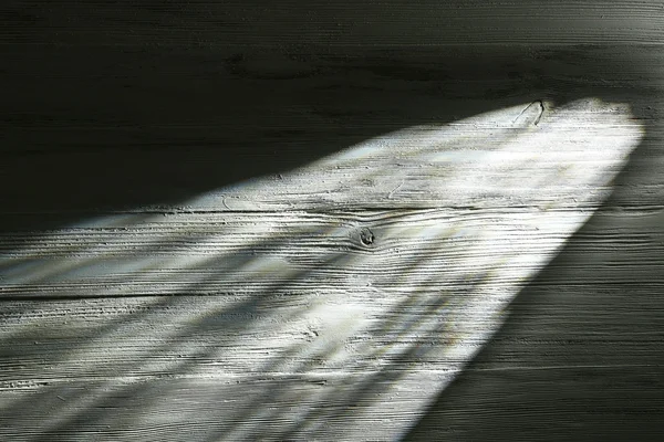 Haz de luz sobre fondo de madera — Foto de Stock