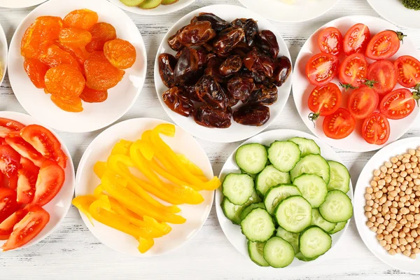 Different products on saucers — Stock Photo, Image