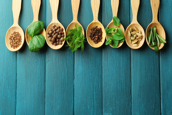 Wooden spoons with fresh herbs and spices