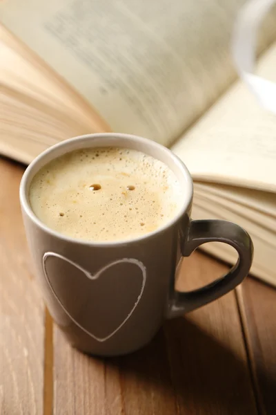 Still life with cup of coffee and book, on wooden table — Stock Photo, Image