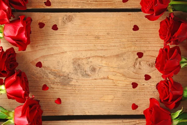 Red roses on wooden background — Stock Photo, Image