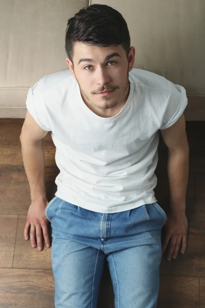 Young man sitting — Stock Photo, Image