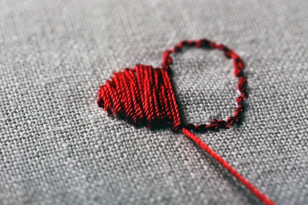 Canvas for embroidery and red sewing threads — Stock Photo, Image