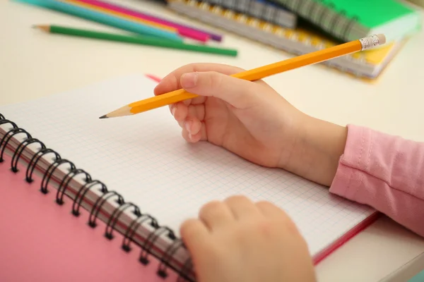 Kids hands drawing on notebook at desktop, closeup — Stock Photo, Image