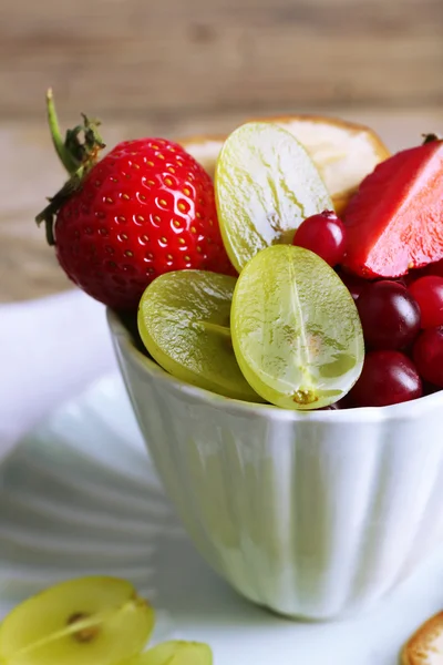 Cup of dessert with fresh fruits on wooden table, closeup — Stock Photo, Image