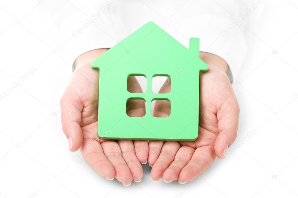Female hands holding house