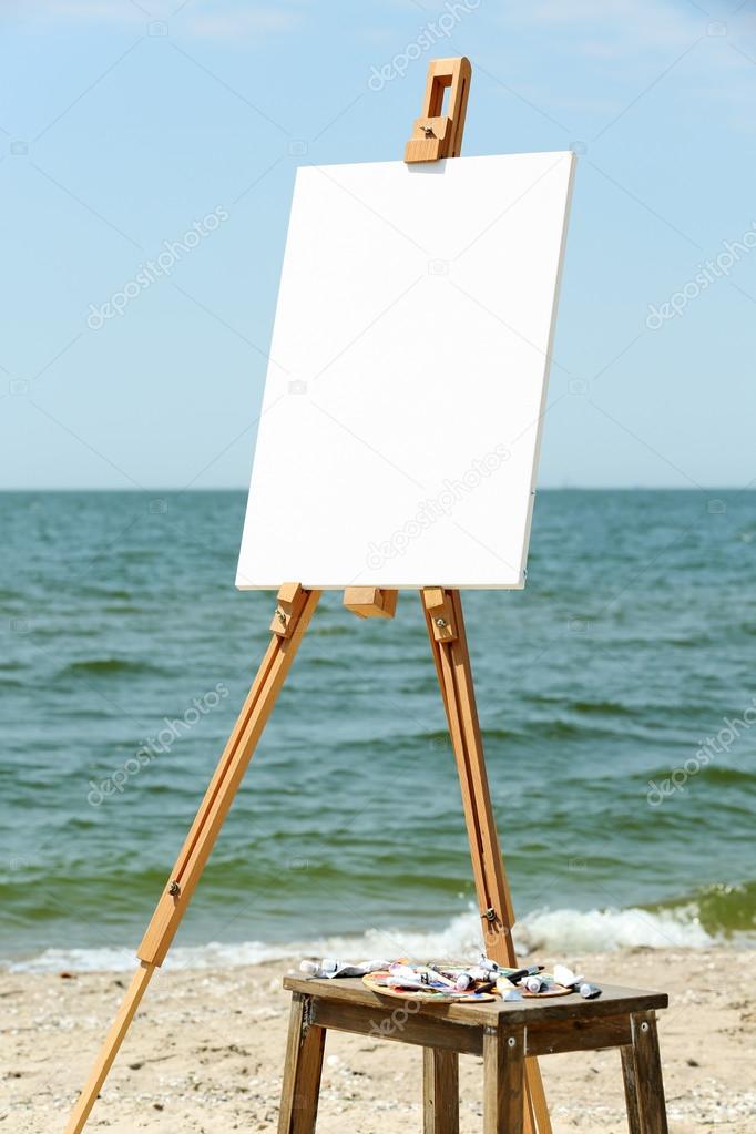 Easel with canvas on beach