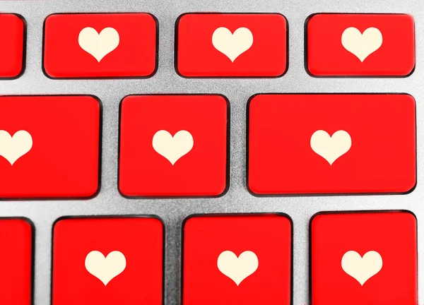 Close up of laptop keyboard with hearts icons — Stock Photo, Image