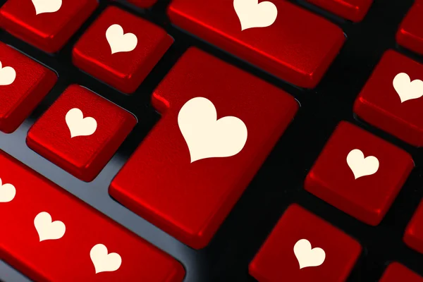Close up of laptop keyboard with hearts icons — Stock Photo, Image
