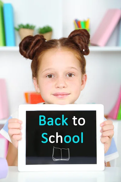 Cute girl with tablet at workplace in classroom — Stock Photo, Image