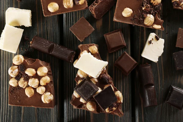 Set of chocolate with hazelnut on wooden table, top view — Stock Photo, Image