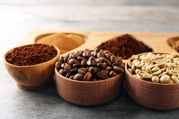 Various of coffee in small dishes on wooden table, closeup — Stock Photo, Image